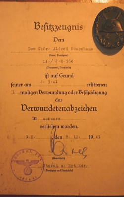 Besitzzeuchnis voor her Verwundetenabzeichen in Schwartz 8-12-41 ook ondertekend door Postel