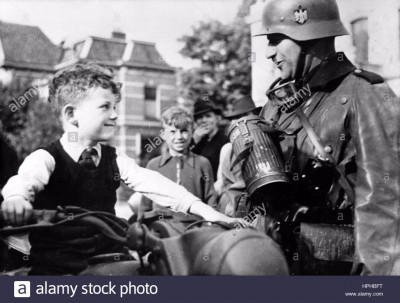 the-nazi-propaganda-image-shows-a-local-boy-on-a-motorcycle-next-to-HPHBFT.jpg